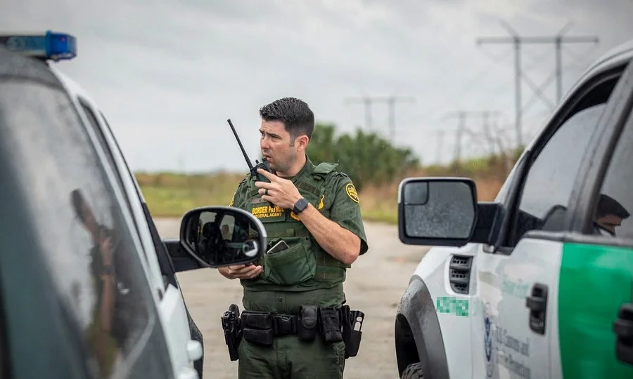 Border Patrol agent inspecting car